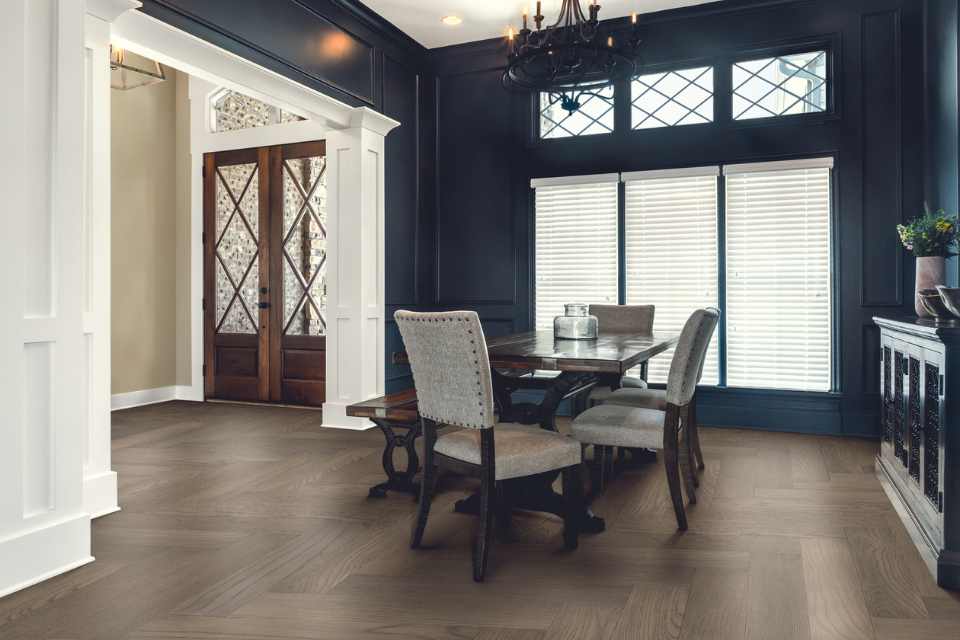 vintage wash herringbone hardwood in dining room with antique chandelier and Victorian style windows